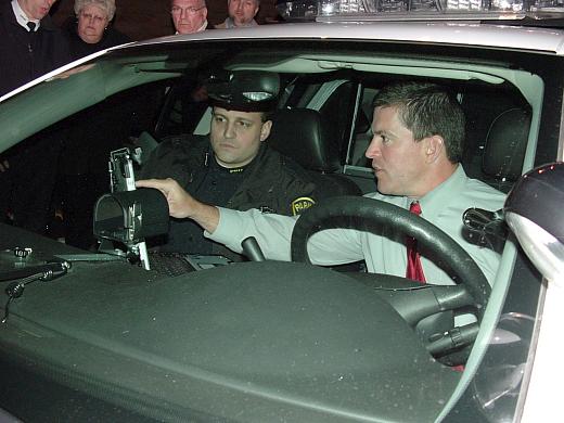 Officer Richard Hach shows Mayor DePiero the new "toughbook" computers that have been installed in some of the Parma police cars.